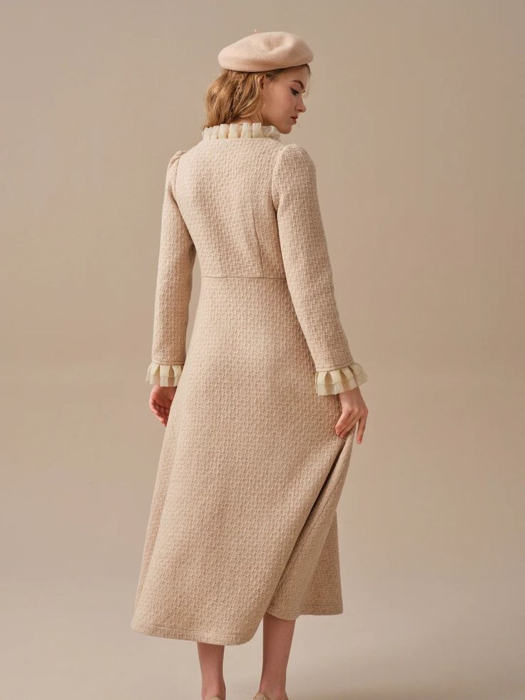 Introducing this exquisite wool dress from our 2023 AW collection, designed to captivate with its vintage charm and elegant details. Crafted from luxurious wool, this dress offers a cozy yet stylish option for chilly days. The combination of the vintage-inspired metal buttons and the whimsical ruffles will transport yo Formal Beige Maxi Dress For Fall, Luxury Long Sleeve Tweed Dress, Winter Feminine Dresses With Ruffles, Feminine Winter Dresses With Ruffles, Feminine Ruffled Winter Dresses, Classic Beige Winter Dresses, Winter Long Sleeve Tweed Dress With Buttons, Elegant Beige Midi Dress For Winter, Elegant Midi Length Tweed Dress