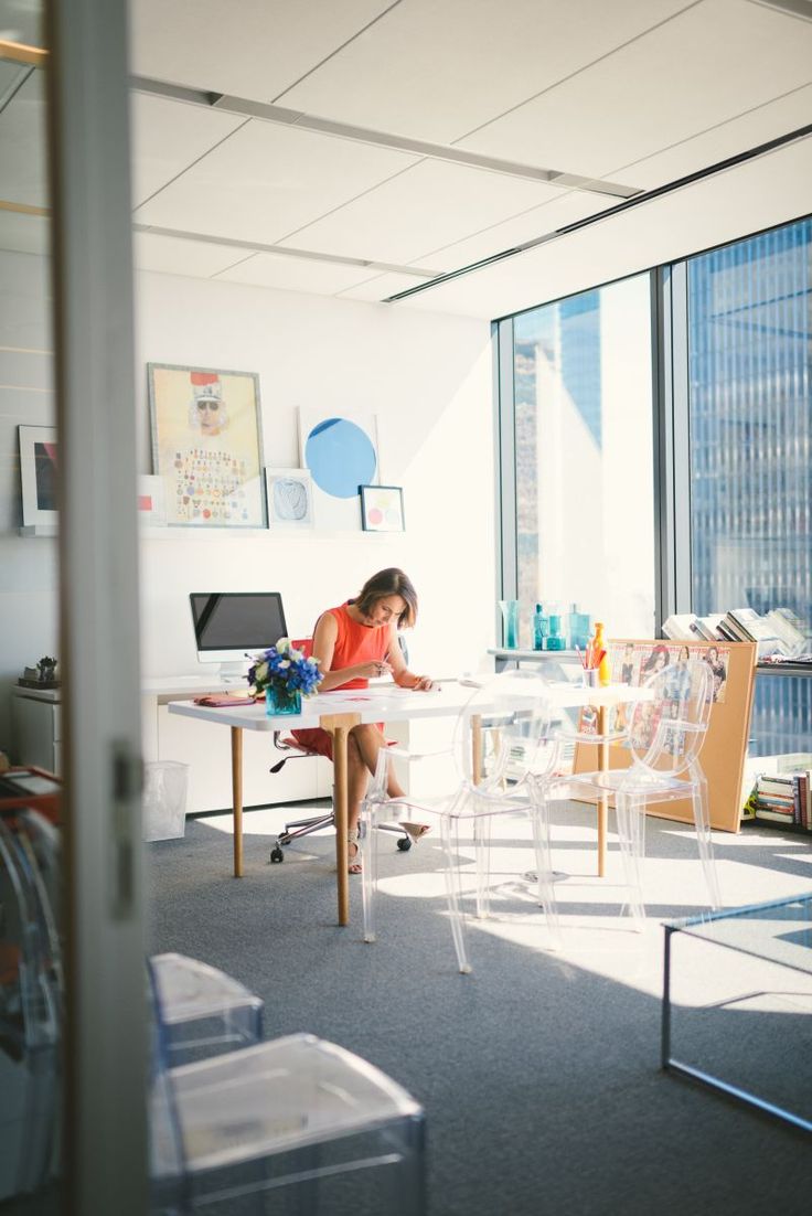 a woman sitting at a desk in an office with the title land the job what to wear for your next interview