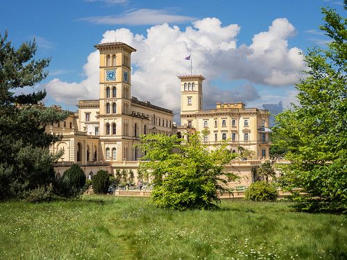 an old building with a clock tower in the middle of it's front yard