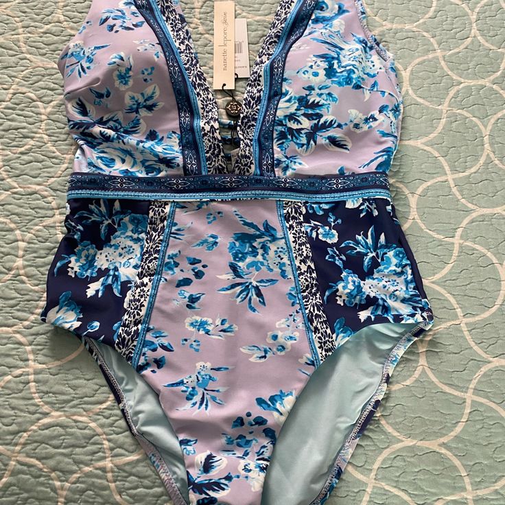 Beautiful New Swimsuit With Various Blues And Purple. Blue Lined Swimwear, Lined Blue Swimwear, Blue Lined Swimwear For Swimming, Blue Lined Swimwear For Beach Season, Lined Blue Swimwear For Beach Season, Blue Lined Tankini For Sunbathing, Lined Blue Tankini For Sunbathing, Blue Floral Print Tankini For Poolside, Blue Floral Print Tankini For Sunbathing