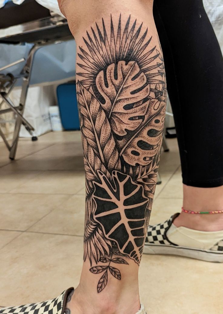 A white leg, featuring a tattoo on the outer left calf, blackwork/dotwork tropical leaves, thick linework, illustrative, flowy. Leg Sleeve Theme Tattoo Designs, Half Leg Sleeve Tattoo Calf, Calf Sleeve Women Tattoo, Plant Tattoo Leg, Leaves Tattoo Sleeve, Nature Leg Tattoo, Plant Leg Tattoo, Half Leg Sleeves For Females, Lower Leg Sleeve Tattoo