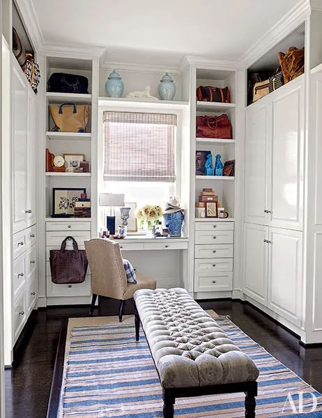 a living room with white cabinets and a blue rug