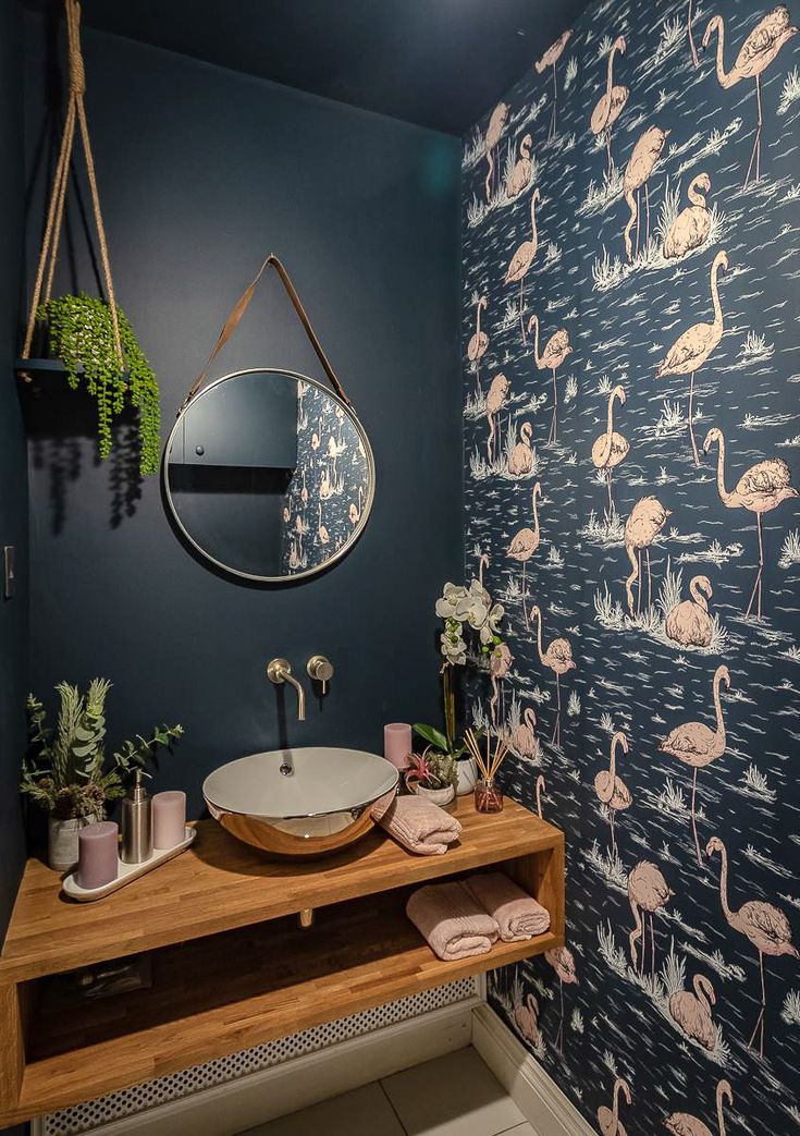 a bathroom with flamingos on the wall next to a mirror and sink in it