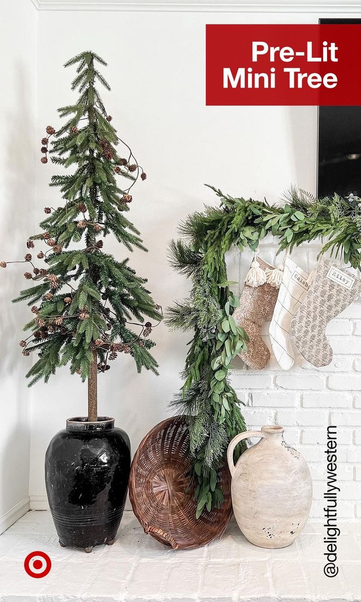 christmas decorations are displayed in front of a white brick wall with red lettering that reads pre - lit mini tree