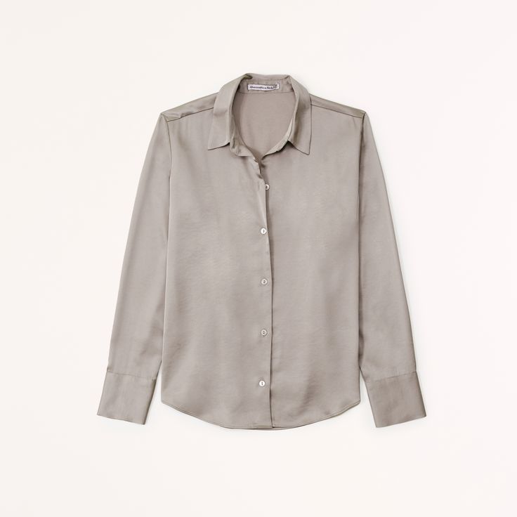 Elevate your wardrobe with the Abercrombie & Fitch Women's Long-Sleeve Satin Button-Up Shirt, a blend of sophistication and comfort. Perfect for any occasion, this shirt features:

- Size: Large
- Color: Taupe
- Material: Polyester, Viscose
- Gender: Female
- Classic collar and curved hem
- Relaxed-fit silhouette

Crafted in a luxurious satin fabric, this top offers a smooth feel and a subtle sheen that catches the light beautifully, enhancing its elegant taupe hue. The relaxed fit ensures comfo Affordable Neutral Button-up Blouse, Medium Wash Relaxed Fit Button-up Shirt, Medium Wash Button-up Shirt, Satin Long Sleeve Shirt With Button Closure, Cheap Garment Washed Button-up Shirt, Satin Button Up, Female Features, Button Up Shirt Womens, Female Style