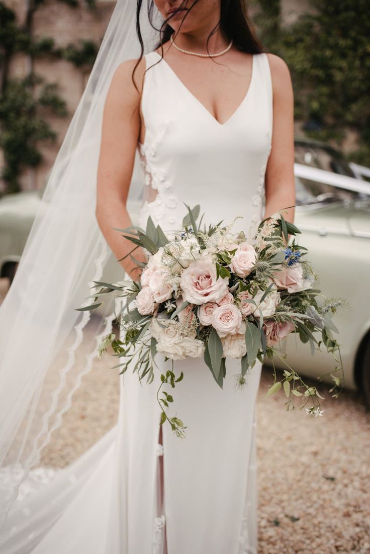 a woman in a wedding dress holding a bouquet