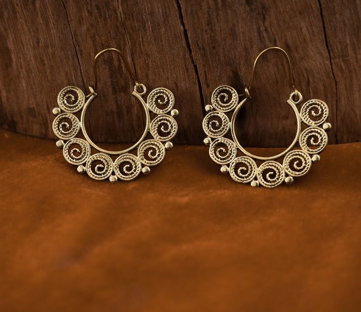 ↠Handcrafted in India. ↠These earrings are handcrafted with brass ↠The color of brass is very close to gold, which makes it quite attractive. ↠Wire thickness is 0.1 cm These earrings are made for standard holes PLEASE NOTE that You don't need a PayPal Account to pay for your items via PayPal. You can pay by simply: ↠ Choose PayPal at checkout. ↠ After you submit your order click the PAY NOW button. ↠ Scroll Down and you will see the option to pay with a Credit/Debit Card WITHOUT having to log in Spiral Jewelry With Intricate Design For Gift, Handmade Adjustable Traditional Hoop Earrings, Festive Filigree Hoop Earrings Gift, Traditional Handmade Adjustable Hoop Earrings, Festival Hoop Filigree Earrings, Traditional Nickel Free Small Hoop Earrings, Traditional Nickel-free Small Hoop Earrings, Traditional Nickel-free Hoop Earrings For Wedding, Festival Spiral Gold Earrings