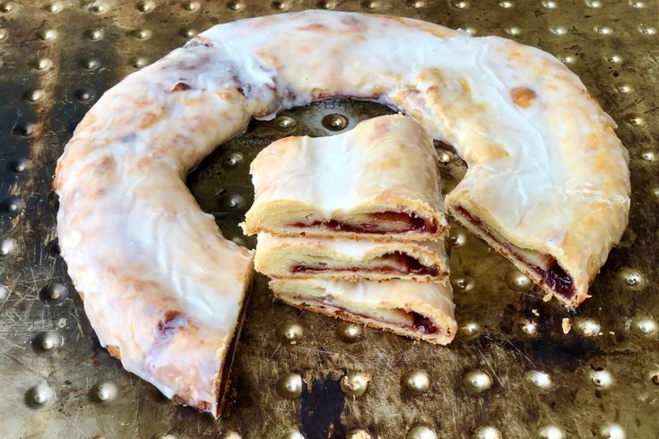 a doughnut that has been cut in half and is sitting on a metal surface