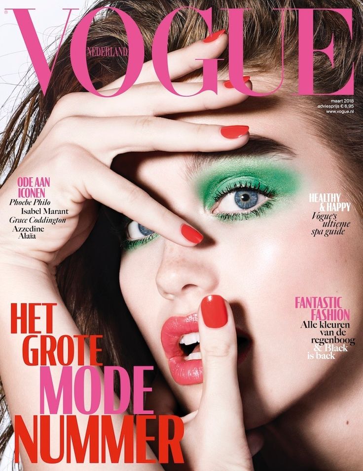 a woman with red and green makeup on the cover of a magazine, holding her hand to her face