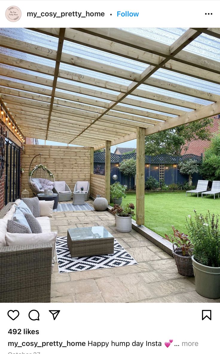 an outdoor living area with couches, chairs and a pergolated roof over it