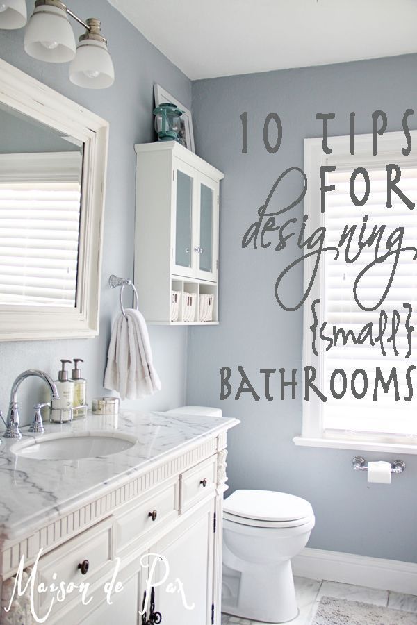 a bathroom with blue walls and white fixtures