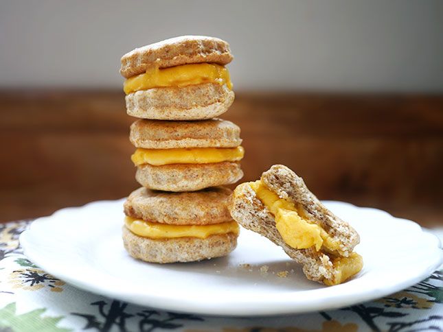 a stack of mini sandwiches sitting on top of a white plate