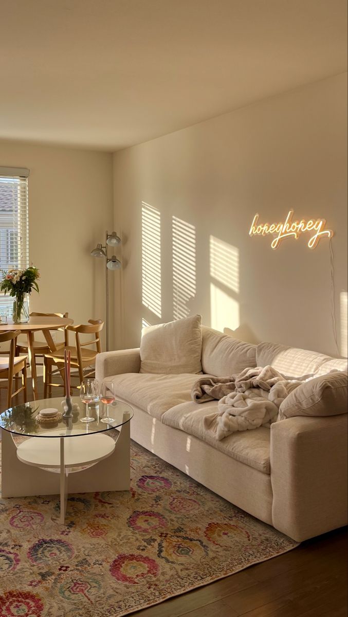 a living room filled with furniture next to a table and chairs on top of a rug