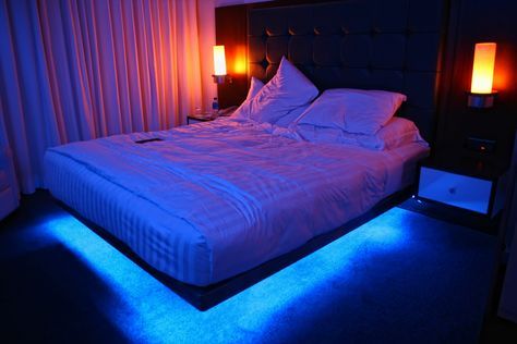 a bed with two lamps on either side of it