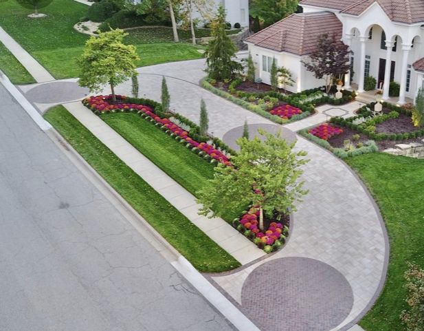 an aerial view of a home with landscaping