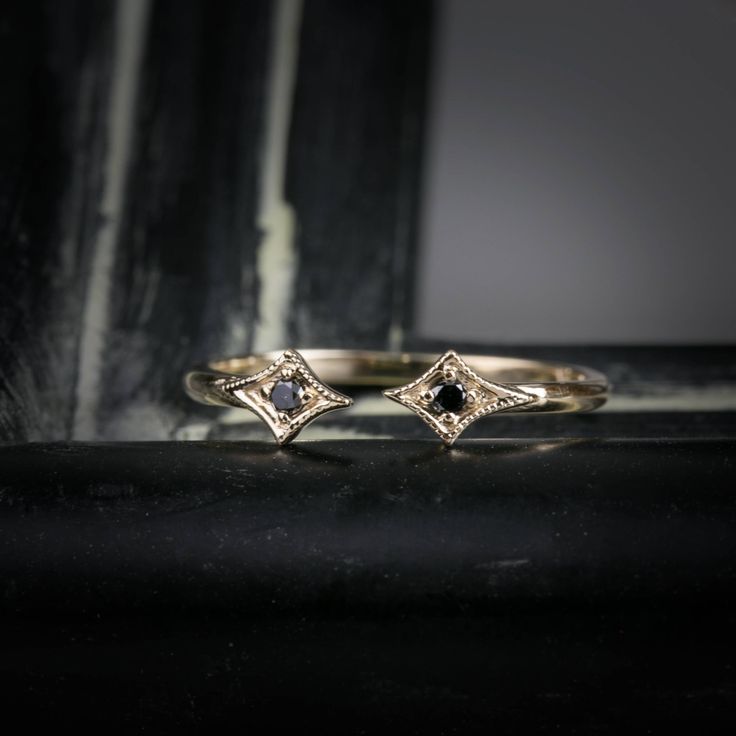 "\"Open star ring \" is a unique wedding band designed to accentuate your engagement ring that sits above. The style is sophisticated and dainty. The gap between two stars measures about 2~3mm, and it can be customized upon request. Details :: Material Option: 14k yellow, white, rose gold or platinum :: Band width: 1.3mm :: Height : 3.7mm :: Total diamond carat weight: .03ct :: Size of the gap between stars : 2~3mm :: Made with 100% recycled metal and ethically sourced gemstones. :: Design name: Celestial Single Cut Diamond Promise Jewelry, Celestial Style Promise Jewelry With Single Cut Diamonds, Adjustable Promise Rings With Single Cut Diamonds, Adjustable 14k Gold Rings With Rose Cut Diamonds, 14k White Gold Jewelry With Black Diamonds, Celestial Promise Ring With Single Cut Diamonds, Celestial Single Cut Diamond Promise Rings, Luxury Stackable Rings With Rose Cut Diamonds For Promise, Elegant 14k Gold Rings With Black Diamonds