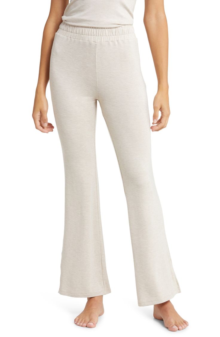 A comfy smocked waistband tops flared-leg lounge pants made from stretchy French terry for a look you can enjoy at home or anywhere. 30" inseam; 12" leg opening; 11 1/2" front rise; 14 1/2" back rise Elastic waist 95% rayon, 5% spandex Machine wash, dry flat Imported Flare Bottoms With Elastic Waistband For Loungewear, Beige Stretch Full Length Sweatpants, Beige Stretch Full-length Sweatpants, Casual Flare Bottoms For Loungewear, Casual Flare Yoga Pants For Loungewear, Relaxed Fit Flare Loungewear Bottoms, Relaxed Fit Flare Bottoms For Loungewear, Comfortable Beige Leisure Bottoms, Casual Flare Wide Leg Loungewear Pants