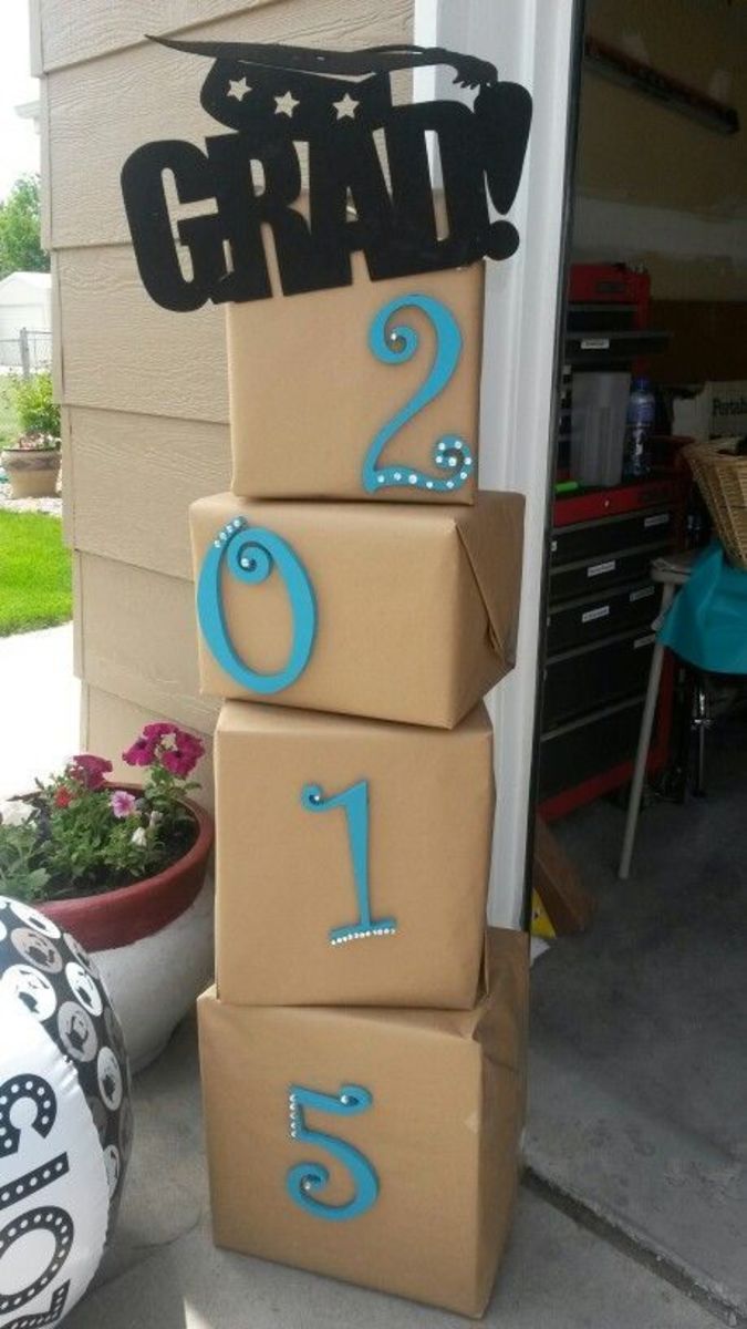 cardboard boxes stacked on top of each other in front of a house with the numbers painted on them