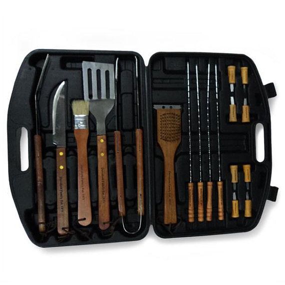 an open tool box filled with different tools and wooden utensils on top of a white surface