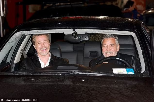 two men in a car talking to each other