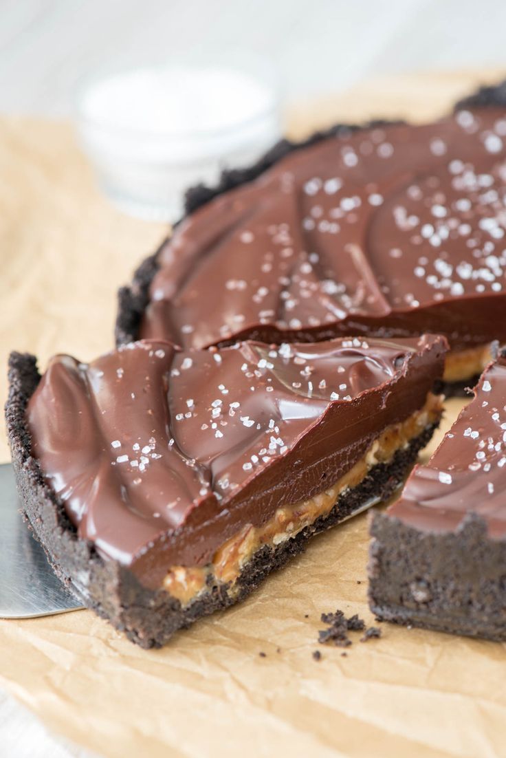 there is a chocolate pie on the table with one slice cut out and ready to be eaten