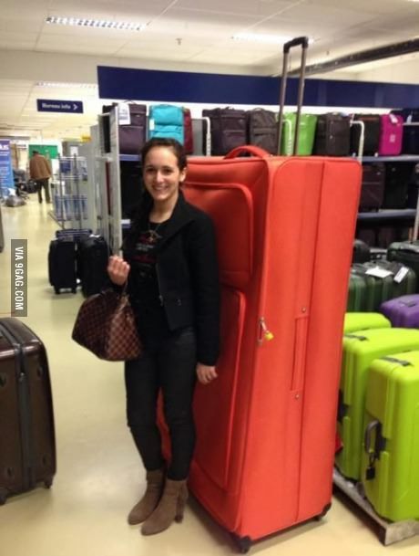 a woman standing next to a red piece of luggage in a store with the caption porto solo una valigia