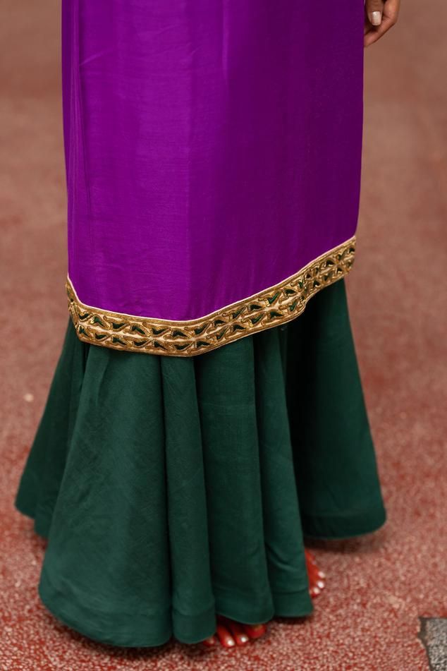 Violet woven kurta with floral embroidery on the border. Paired with sharara and dupatta.
Components: 3
Pattern: Embroidered, Woven
Type Of Work: Floral
Neckline: Round
Sleeve Type: Full
Fabric: Kurta, Sharara: Munga Silk, Dupatta: Organza Silk
Color: Purple, Green
Other Details: 
Model height: 5ft 7inches, wearing size S
Length: 48 inches
Occasion: Puja - Aza Fashions Elegant Raw Silk Sharara For Traditional Ceremonies, Traditional Silk Wear With Border, Elegant Green Lehenga With Embroidered Border, Elegant Traditional Wear With Border For Eid, Semi-stitched Purple Kurta With Embroidered Border, Semi-stitched Traditional Wear With Border For Eid, Elegant Sharara For Navratri Traditional Ceremonies, Elegant Purple Sets With Embroidered Border, Designer Sharara With Straight Kurta And Embroidered Border