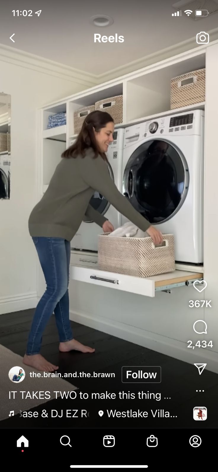 the woman is loading her clothes into the washer