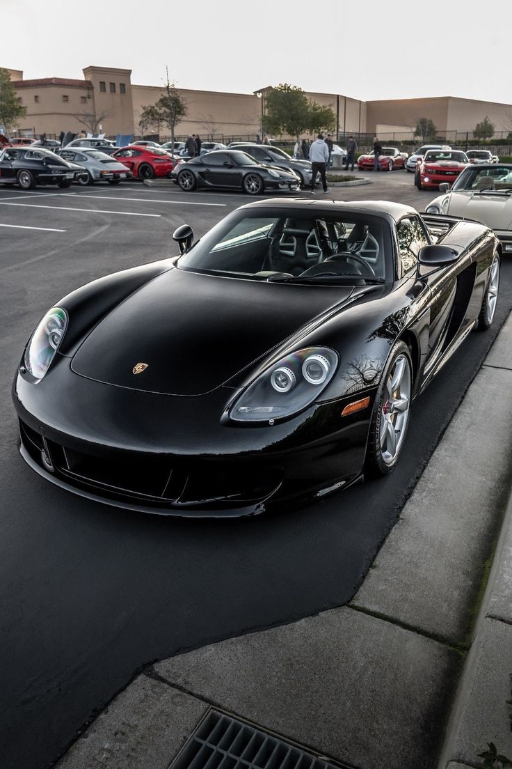 a black sports car parked in a parking lot