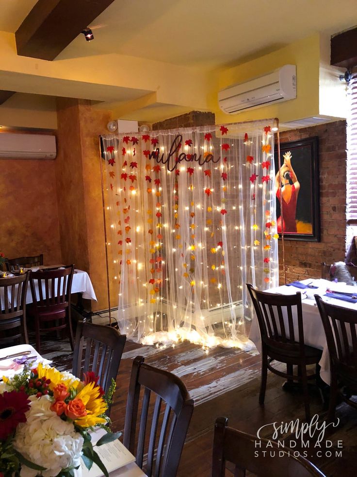 a dining room decorated with flowers and lights