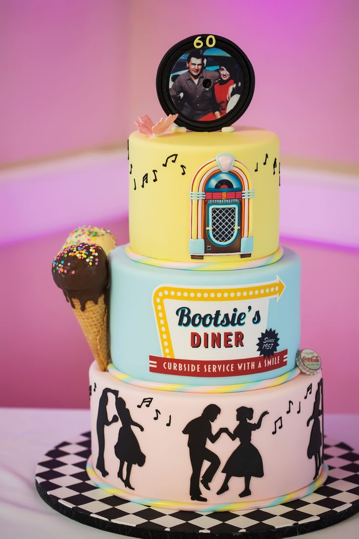 a three tiered cake decorated with an ice cream cone and music notes on top