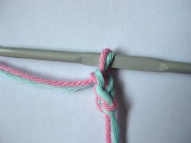 the crochet hook is being used to make a knot