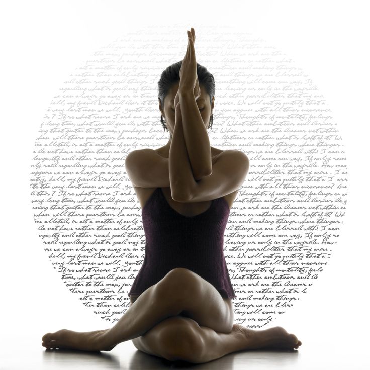 a woman is sitting on the floor doing yoga