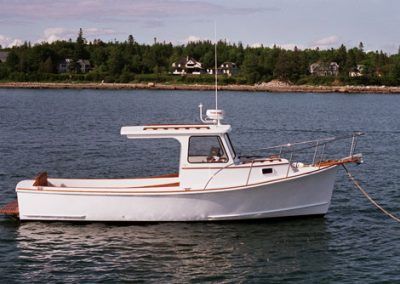 a white boat floating on top of a body of water