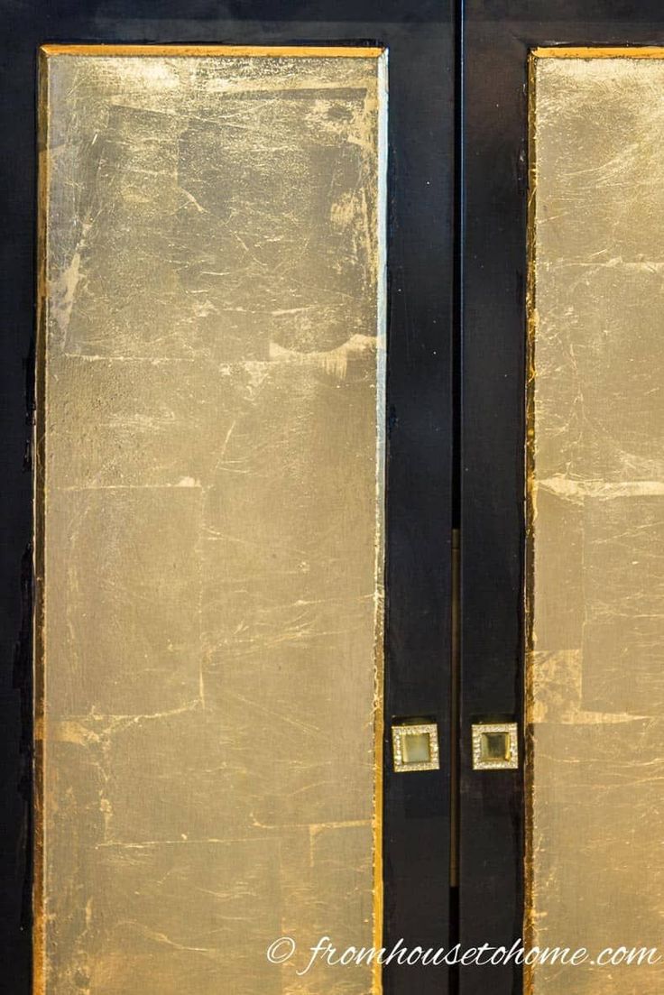 two black doors with gold trim are open