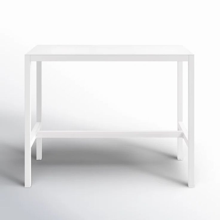 a white table sitting on top of a white floor