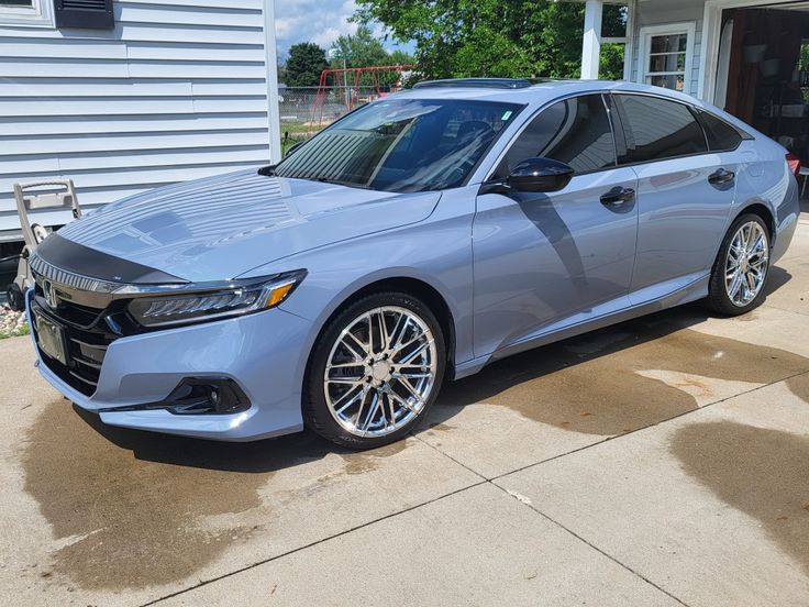 a silver car parked in front of a house