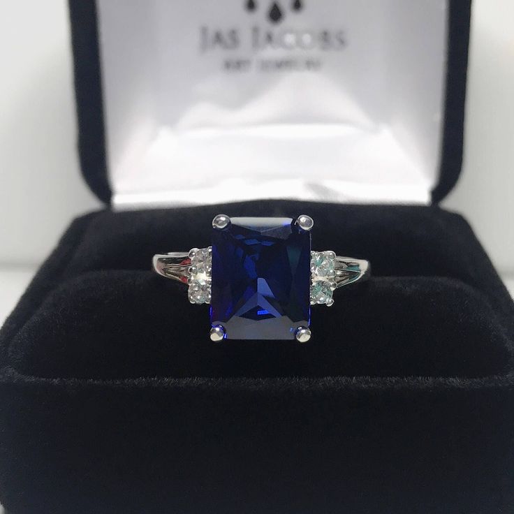 Beautiful Blue & Moissanite Diamond Ring * 4ct Emerald Cut Blue Sapphire measures 10mm x 8mm * 4 Brilliant Cut Moissanite Diamond Accents measure 2mm each (DEF VVS) * 4.28cts total Gemstone weight * 14k Yellow or White Gold - Select Your Color * Sized to Order - Select Your Size Hallmarked & Gift Ready! Matching Earrings & Ring Also Available! This Sapphire is Laboratory Grown. It is identical to natural in every way, including Chemistry, Composition & Hardness with Excellent Clarity & Color Ref Emerald Cut Sapphire Ring, Ring Emerald Cut, Blue Moissanite, Emerald Cut Diamond Ring, Diamond Wedding Rings Sets, White Sapphire Ring, Moissanite Diamond Rings, Fine Art Jewelry, Ring Moissanite