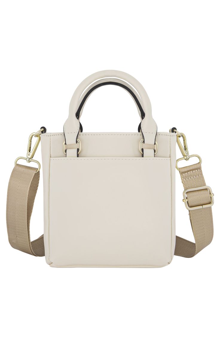 A soft webbed shoulder strap promises a comfortable hands-free fit to a faux leather mini tote bag with top handles to comfortably carry weekend essentials in style. 7" H x 6" W x 2" D Dual rolled top handles, optional crossbody strap Magnetic top closure Polyproplene Lined Imported Trendy White Phone Bag For Shopping, Beige Shoulder Bag With Adjustable Handle For On-the-go, Trendy White Bucket Bag With Top Carry Handle, White Shoulder Phone Bag For Shopping, Top Handle Phone Bag With Adjustable Strap For Shopping, Trendy White Phone Bag With Adjustable Strap, Cream Handheld Shoulder Bag For On-the-go, White Handheld Phone Bag For Everyday Use, White Satchel Phone Bag With Adjustable Strap