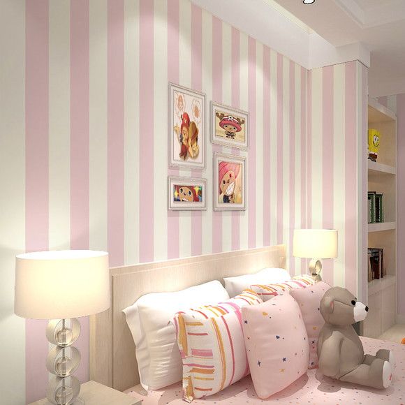 a bedroom with pink and white striped walls