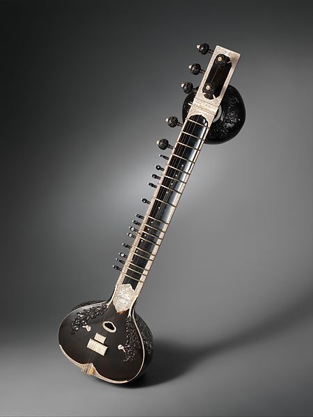 an electric guitar is shown with its neck and frets attached to the back of it