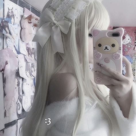 a woman with long white hair is taking a selfie