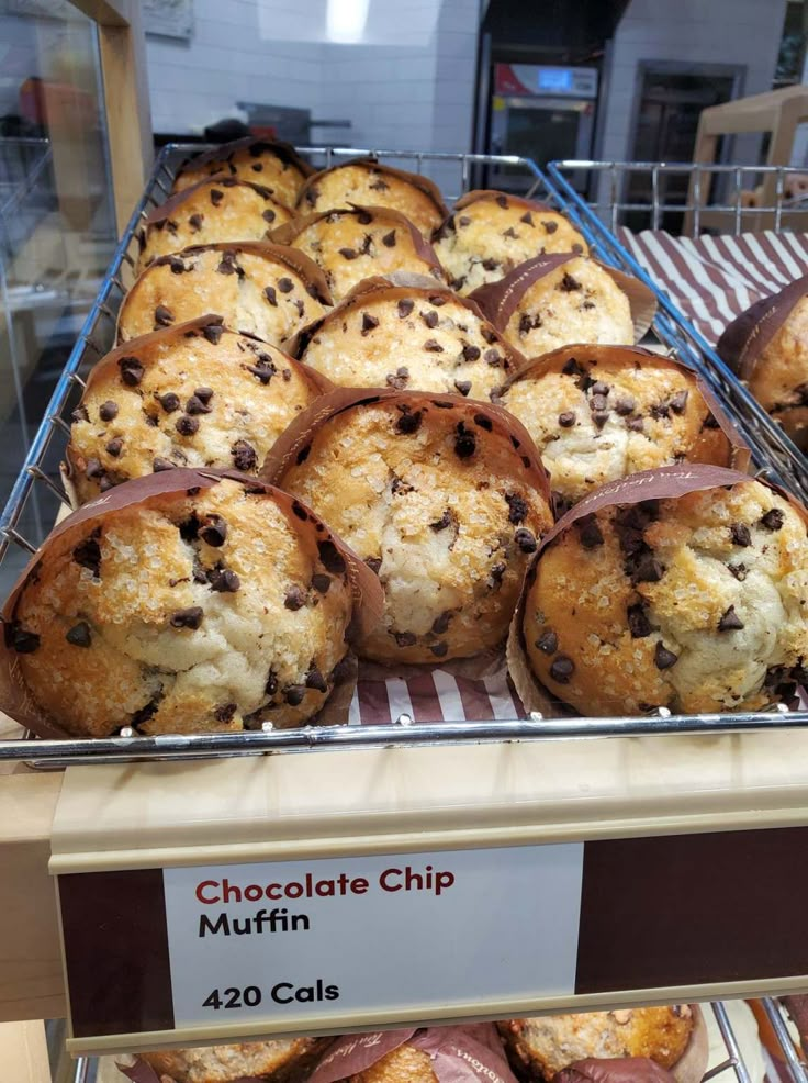 chocolate chip muffins in a display case at a bakery