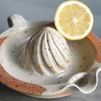 an orange slice is sitting on top of a bowl