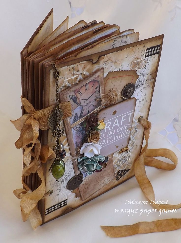 an altered book with ribbon on the cover