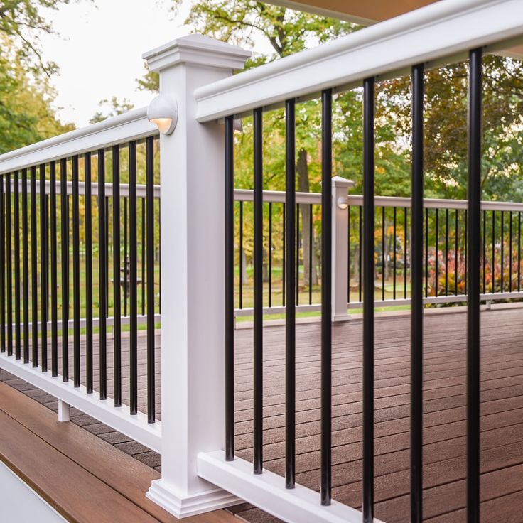 a deck with black and white railing on it