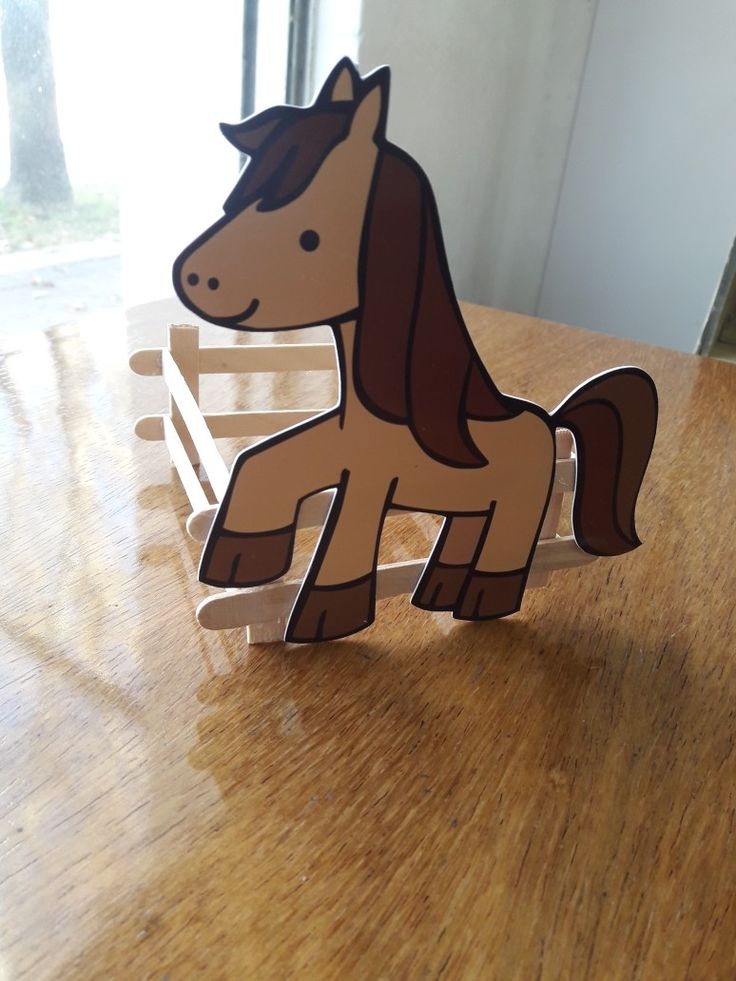 a wooden toy horse sitting on top of a table