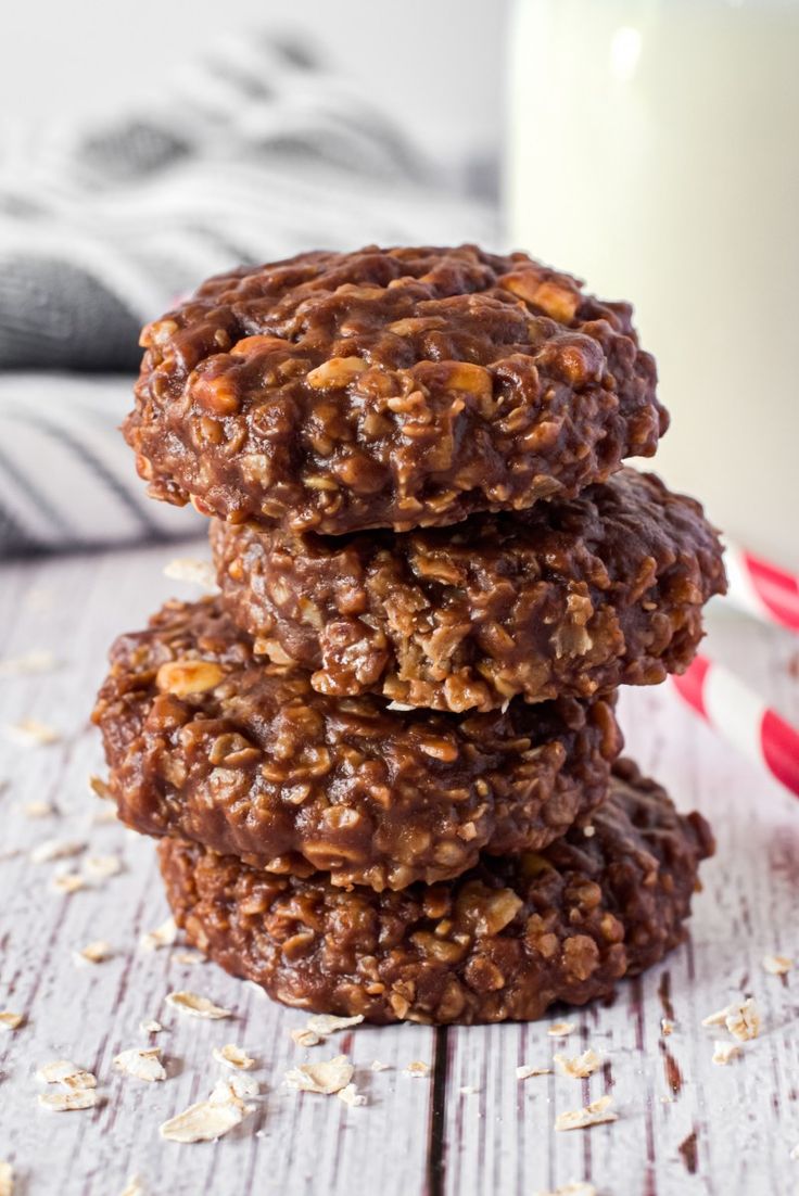 no bake cookies stacked on top of each other in front of a glass of milk