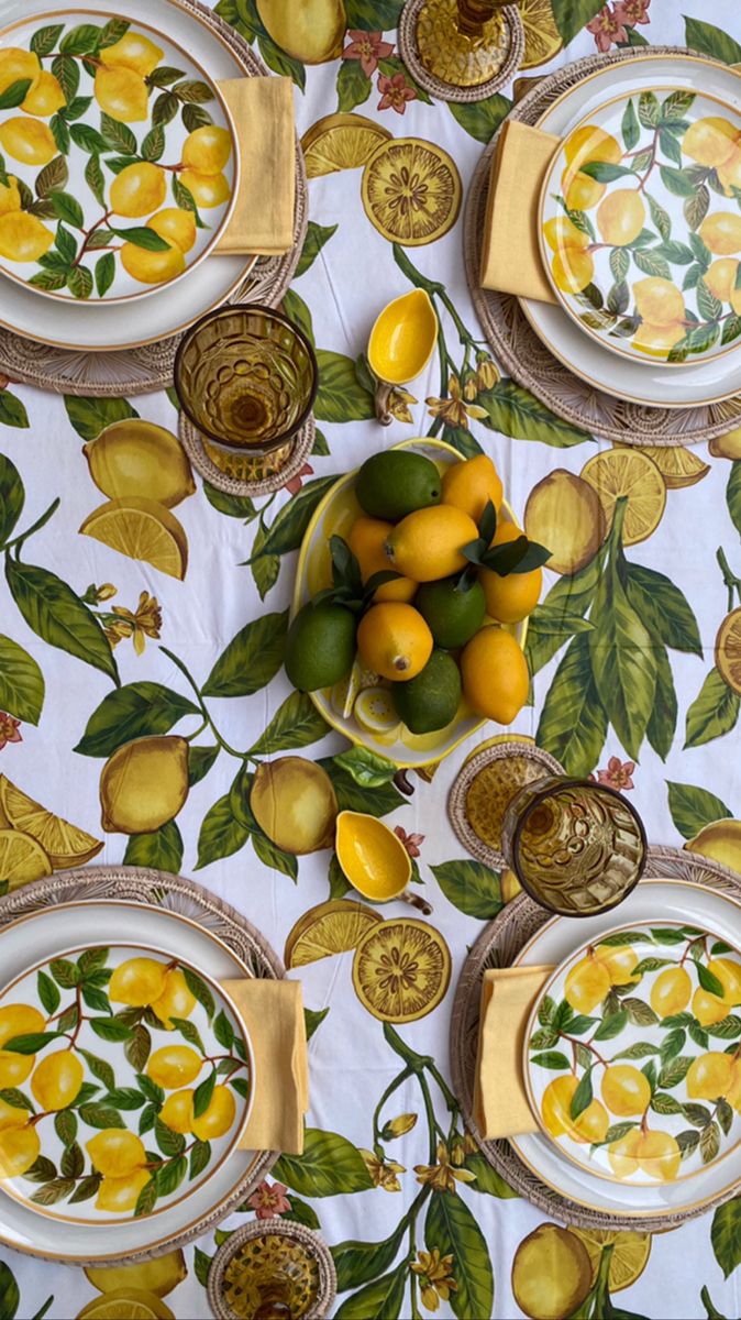 a table topped with plates covered in lemons and limes