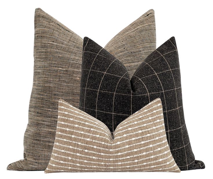 two black and brown pillows on a white background, one has a checkered pattern